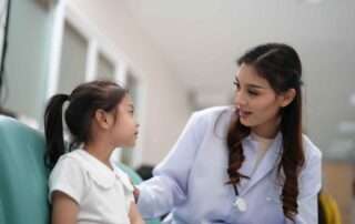Child talking with pediatric specialist during early developmental assessment session at OrbRom Center in Phnom Penh.