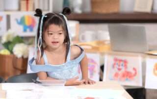Young child with special needs participating in occupational therapy session at OrbRom Center in Phnom Penh to build motor and life skills.
