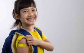 Smiling schoolgirl with backpack and notebook, ready to return to school—representing confidence and special needs readiness.