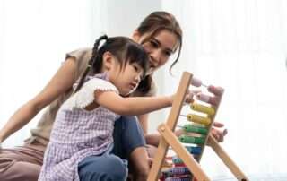 Young child learning to speak through a speech therapy session at OrbRom Center Phnom Penh
